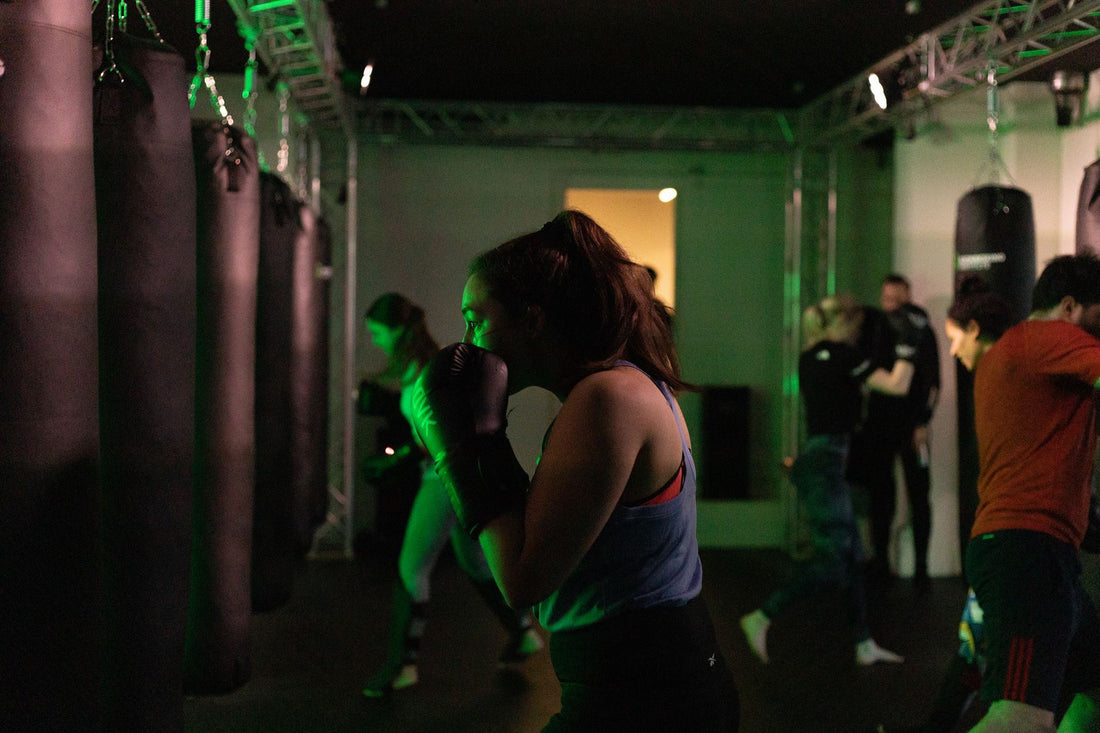 Kickboxing institute woman on a punching bag for class