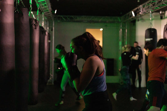 Kickboxing institute woman on a punching bag for class